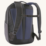 A reverse image of the Patagonia 24L smolder blue atom day pack in  showing the padded shoulder strap and pale black chest strap detail