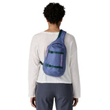 The back of a woman wearing the Patagonia atom 8 litre sling bag in current blue available at Babipur 