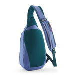 The Patagonia atom 8 litre sling bag in current blue available at Babipur showing the padded shoulder strap and back panel detail with green trim