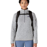 Front of woman wearing Patagonia's atom 20 litre tote pack in black with matching  shoulder straps and quick release buckle 