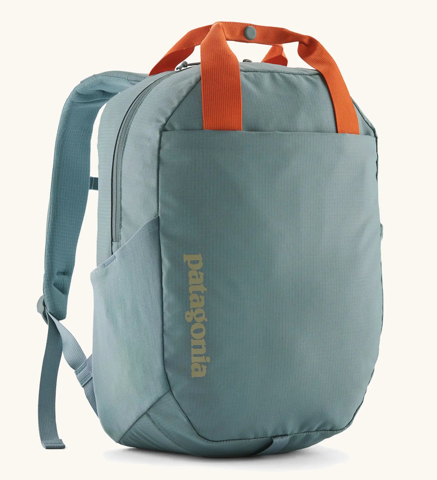 Patagonia atom 20 litre tote pack in sage blue with orange top handle zipped compartment and side pocket