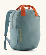 Patagonia atom 20 litre tote pack in sage blue with orange top handle zipped compartment and side pocket