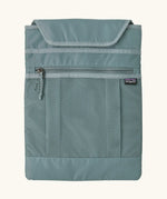 Extra laptop sleeve included with Patagonia atom 20 litre tote pack in sage blue showing extra zipped front pocket