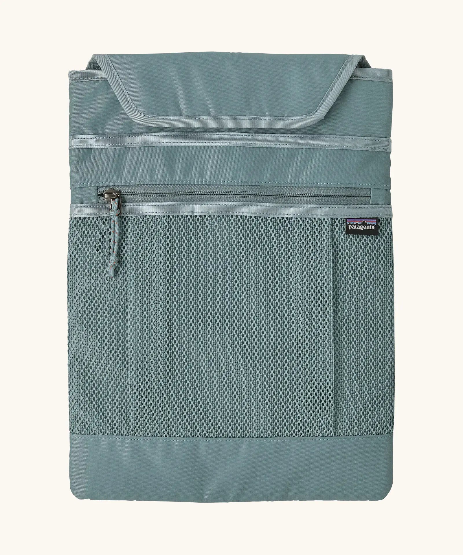 Extra laptop sleeve included with Patagonia atom 20 litre tote pack in sage blue showing extra zipped front pocket