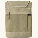 Extra laptop sleeve included with Patagonia atom 20 litre tote pack in light green showing extra zipped front pocket