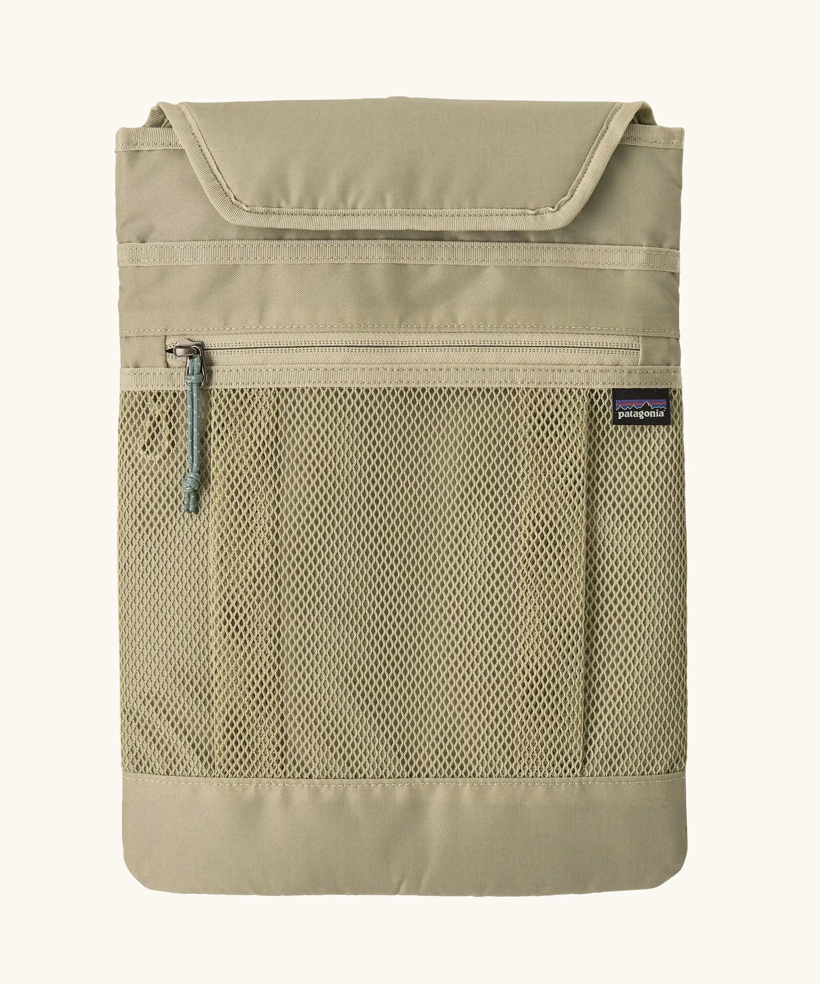 Extra laptop sleeve included with Patagonia atom 20 litre tote pack in light green showing extra zipped front pocket