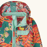 Close up of Patagonia red baby baggies hooded jacket with repeating abstract tropical pattern. Shows light blue chest pocket with popper