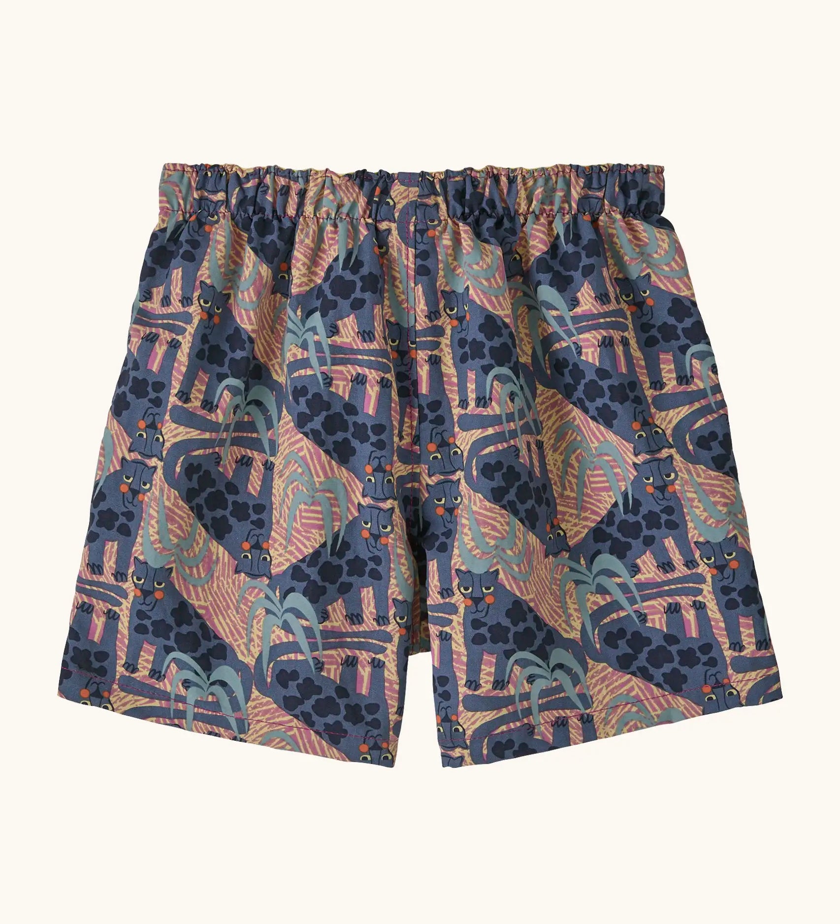Back of Patagonia baby baggies quick drying shorts in blue with repeating abstract and lion design. 