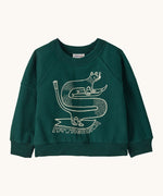 Patagonia Baby Crew Sweatshirt in skisel/cascade green available at Babipur. A green sweater with a funky animal graphic on ski's on the front.