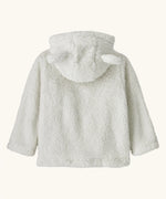 Patagonia baby furry friends hoody in birch white. The back of the soft high-pile recycled polyester fleece, the hood with the bear cub ears is down. 