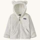 Patagonia Baby Furry Friends Hoody in birch white. Cream Fluffy hooded fleece with a full zip and pockets. Bear cub ears on the hood. Patagonia logo patch stitched on the front.