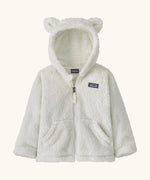 Patagonia Baby Furry Friends Hoody in birch white. Cream Fluffy hooded fleece with a full zip and pockets. Bear cub ears on the hood. Patagonia logo patch stitched on the front.