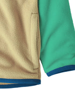 Close up of Patagonia little kids hooded micro d snap t jacket in yellow and green. Showing the side pocket 