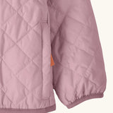 Close up of Patagonia's Little Kids Nano Puff Jacket  in pale purple showing the side pocket and a pink hem and cuff trim