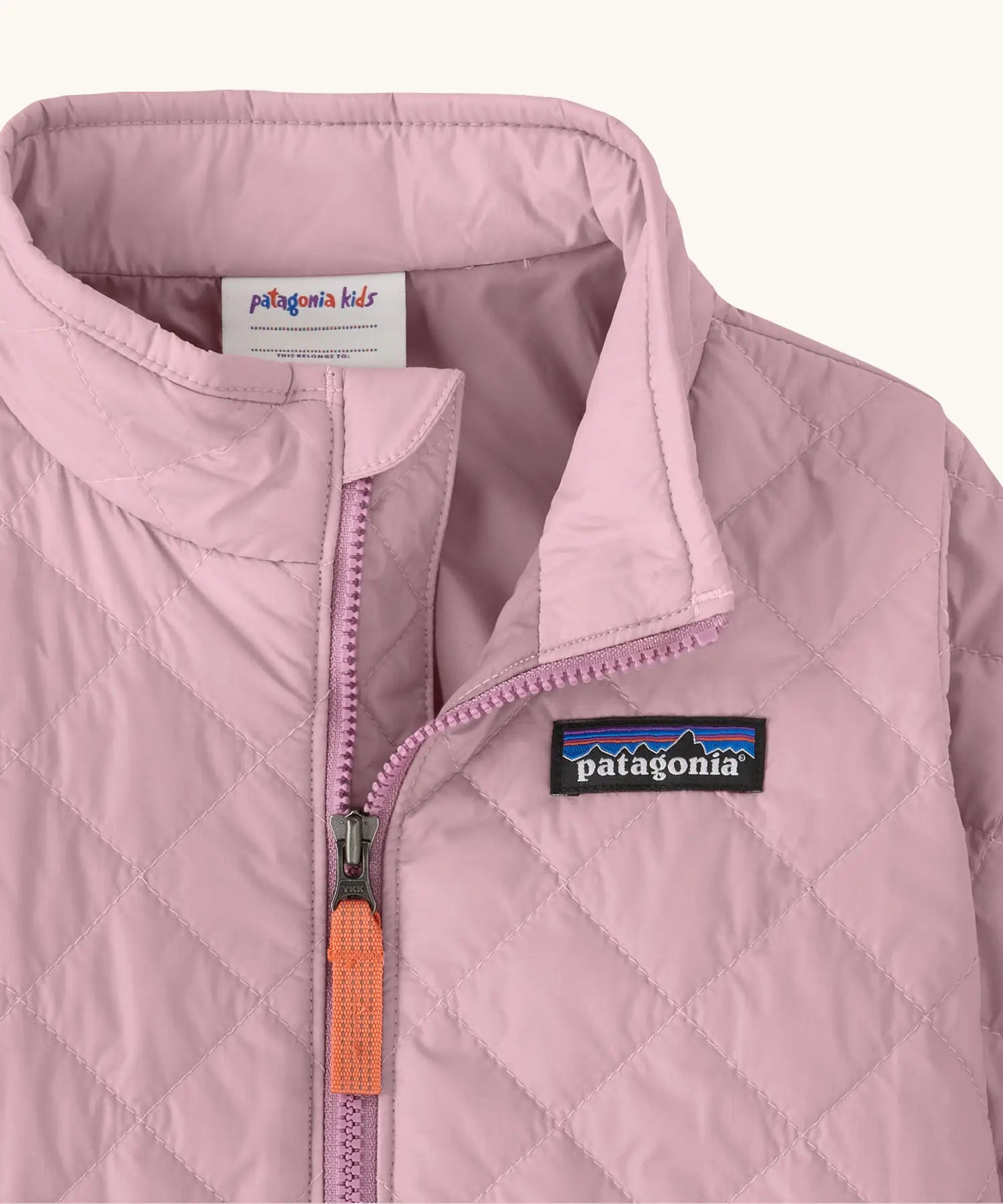 Close up of Patagonia's Little Kids Nano Puff Jacket  in pale purple showing front zip detail and collar