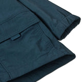 Close up of Patagonia's little kids recycled nylon outdoor everyday jacket in navy showing front velcro pocket and elasticated cuff