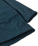 Close up of Patagonia's little kids recycled nylon outdoor everyday jacket in navy showing front velcro pocket and elasticated cuff