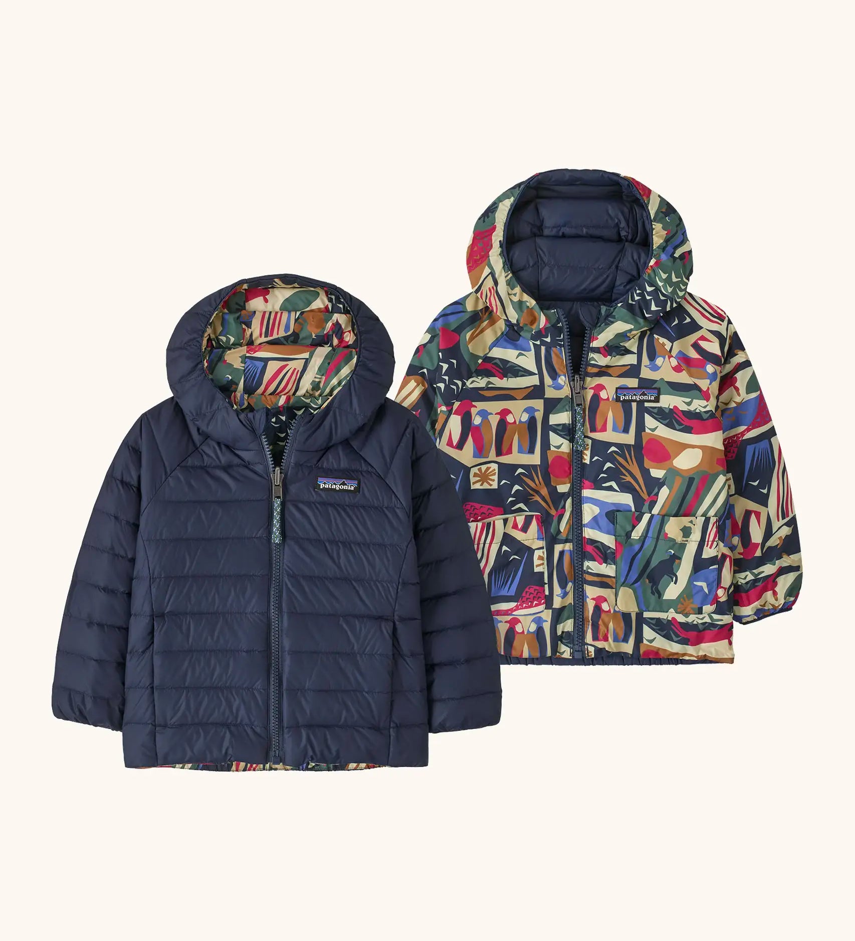 Patagonia baby reversible down hooded sweater jacket in new navy with a repeating colourful abstract design on the reverse. Features a full front zip and pockets