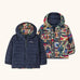 Patagonia baby reversible down hooded sweater jacket in new navy with a repeating colourful abstract design on the reverse. Features a full front zip and pockets