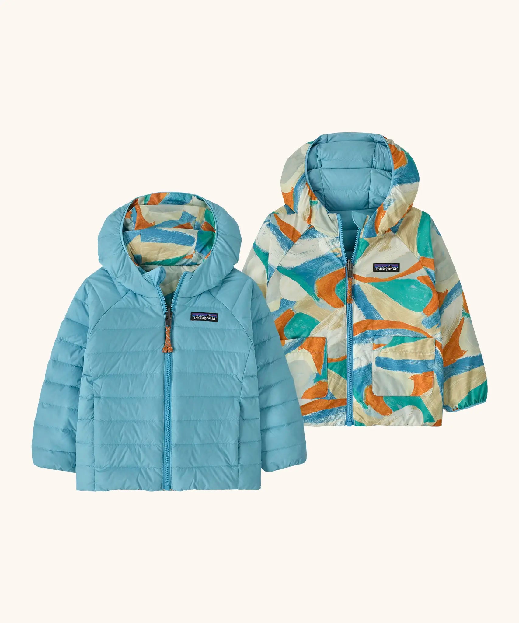 Patagonia baby reversible down hooded sweater jacket in bright blue with a abstract brushstroke design on the reverse. Features a full front zip and pockets