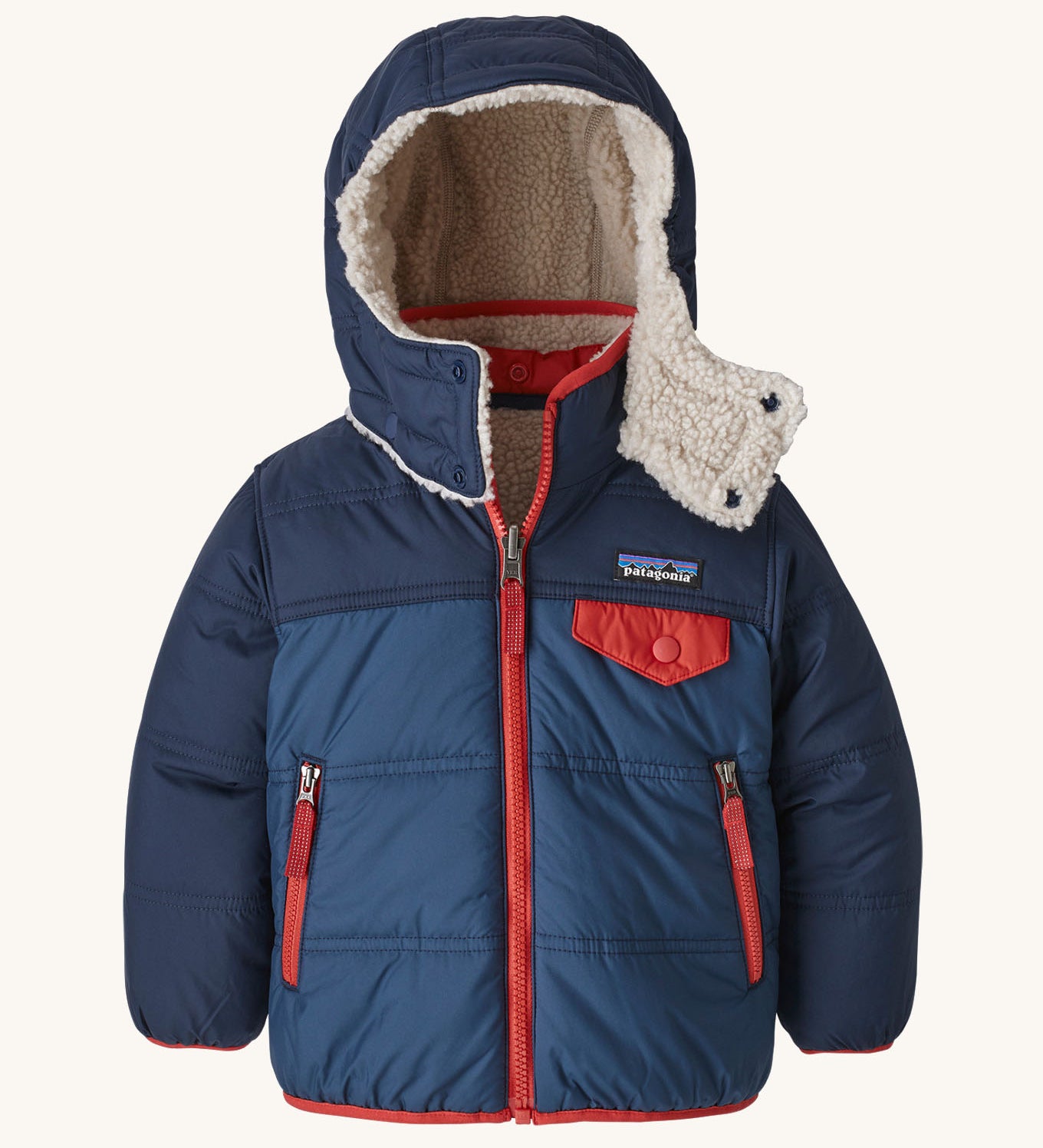 Patagonia reversible little kids tribbles hoody in blue with a fleece inner for warmth. Features a removable hood, chest and side pockets