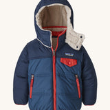 Patagonia reversible little kids tribbles hoody in blue with a fleece inner for warmth. Features a removable hood, chest and side pockets