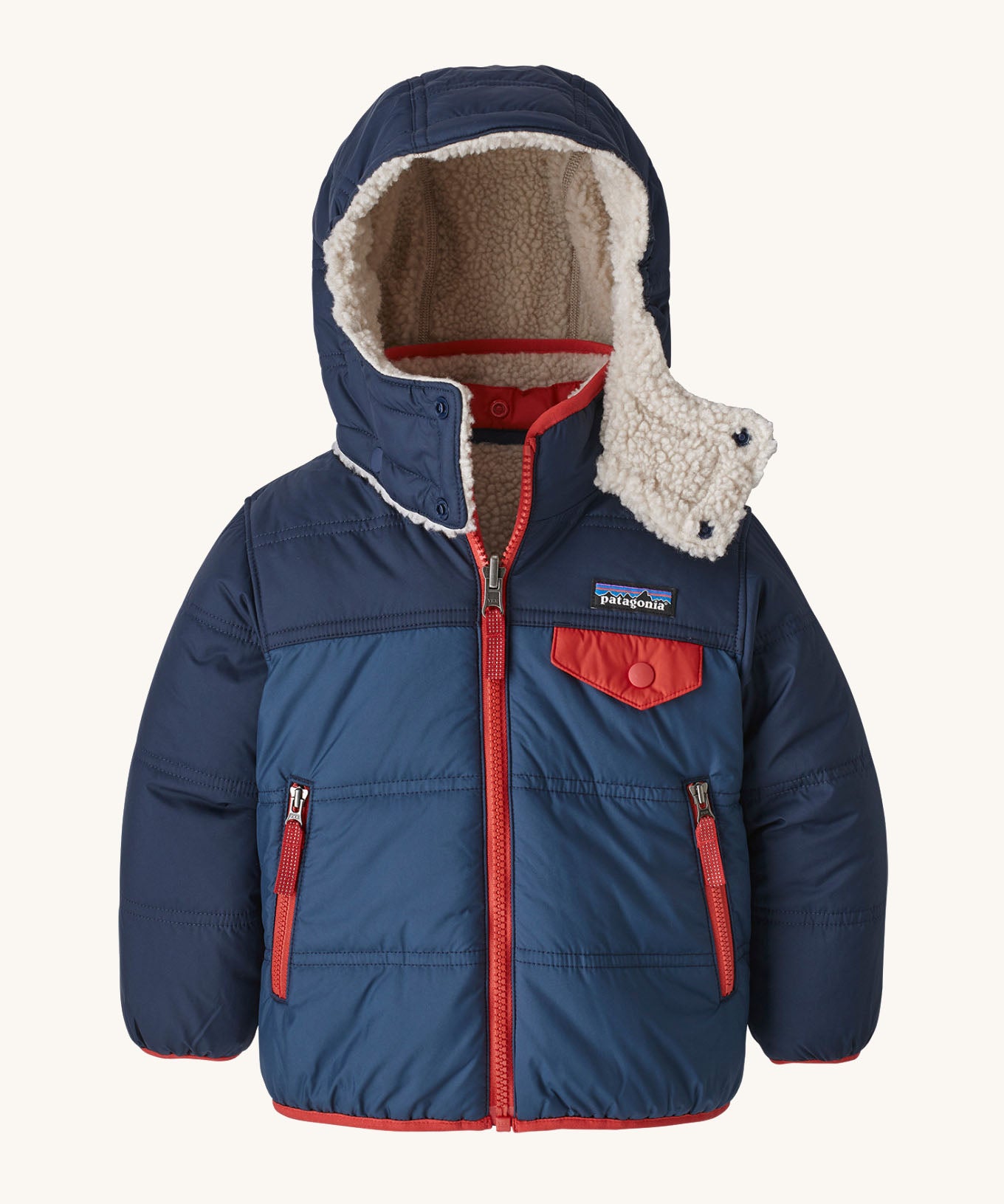 Patagonia reversible little kids tribbles hoody in blue with a fleece inner for warmth. Features a removable hood, chest and side pockets