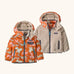 Patagonia reversible little kids tribbles hoody coat in orange with a repeating bunny design and fleece reverse. Features a small chest pocket and side pockets
