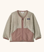 Patagonia baby fleece shearlings jacket in beige with pale pink trim. Features a full length zip and front pockets