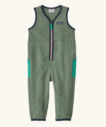 Patagonia baby fleeced shearlings overalls in green with navy trim. Features a half length zip and side pockets