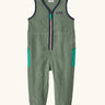 Patagonia baby fleeced shearlings overalls in green with navy trim. Features a half length zip and side pockets