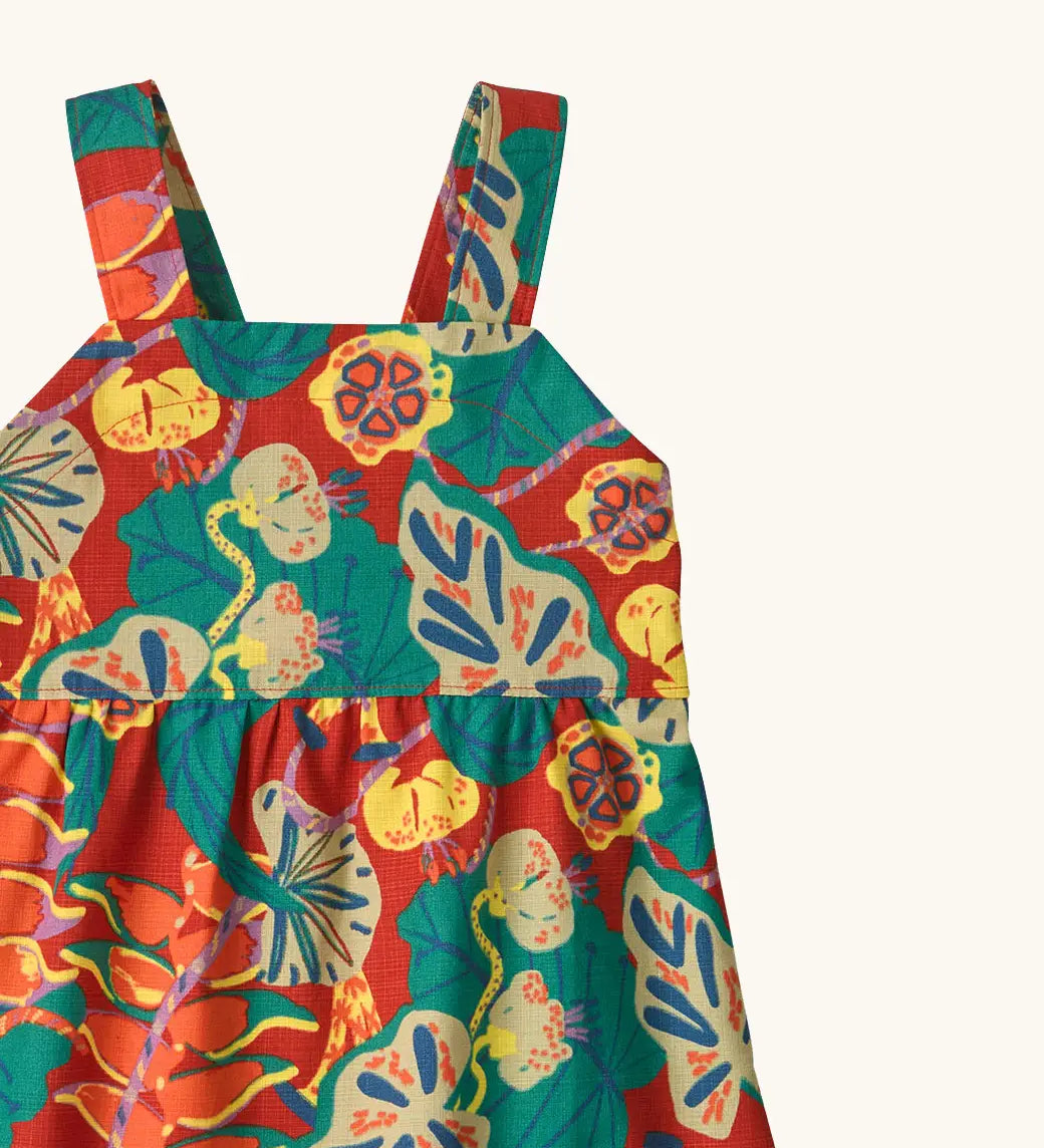 Shoulder straps on Patagonia's little kids tidal thread sleeveless dress in red with repeating abstract tropical pattern
