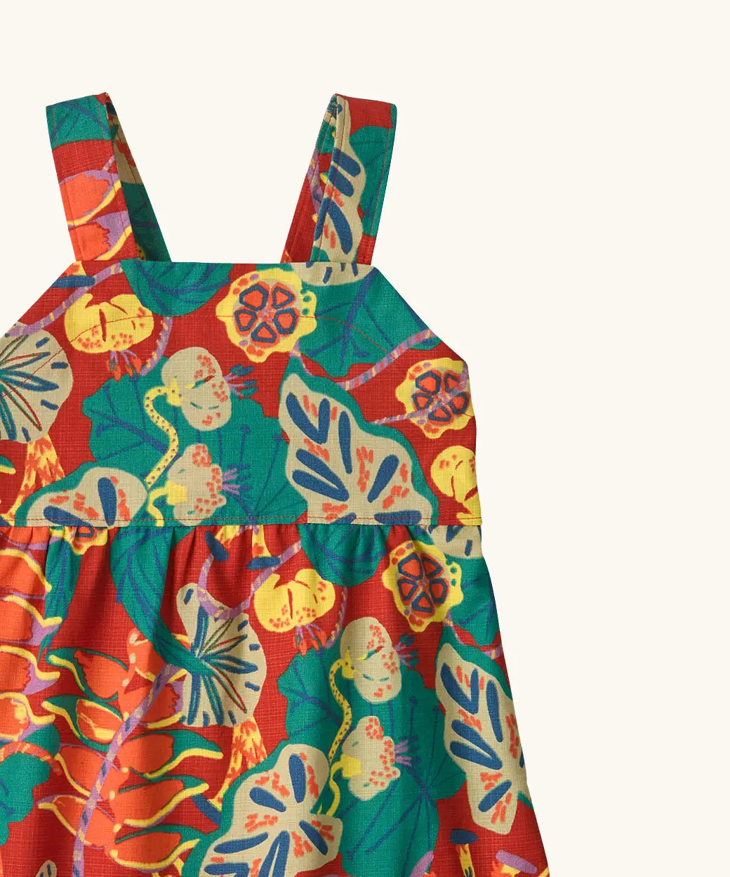 Shoulder straps on Patagonia's little kids tidal thread sleeveless dress in red with repeating abstract tropical pattern
