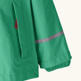 Patagonia little kids torrentshell 3 layer rain jacket in green showing side pocket and reflective strip around arm