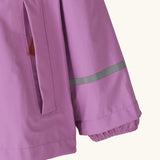Patagonia little kids torrentshell 3 layer rain jacket in bright purple showing side pocket and reflective strip around arm