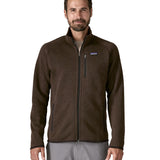 A man wearing the Patagonia men's better sweater in otter brown available at Babipur. A lightweight fleece style jacket with full length zip, 2 side pockets, a chest pocket and features the brand logo patch stitched on the left chest 