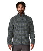 A man wearing the Patagonia men's better sweater in woven together/sunken blue design available at Babipur. A green and blue with a pattern lightweight fleece style jacket with full length zip, 2 side pockets, a chest pocket and features the brand logo patch stitched on the left chest 