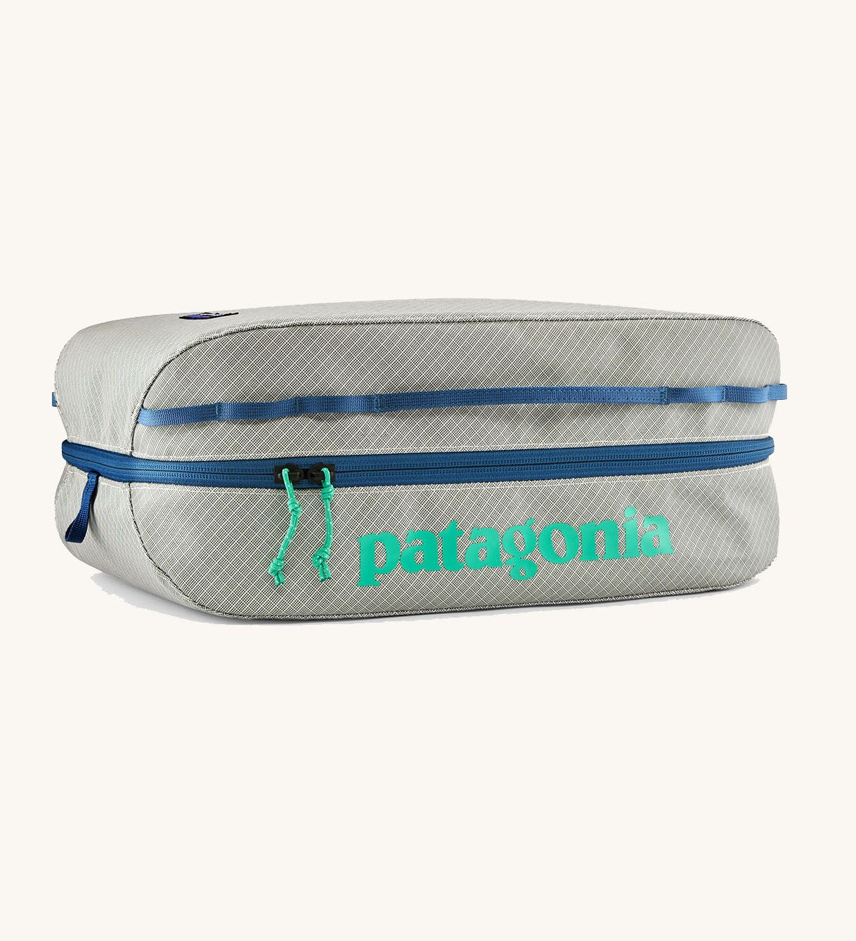 Patagonia black hole 14 litre cube bag in light grey with blue zip and a turquoise brand text logo on front panel