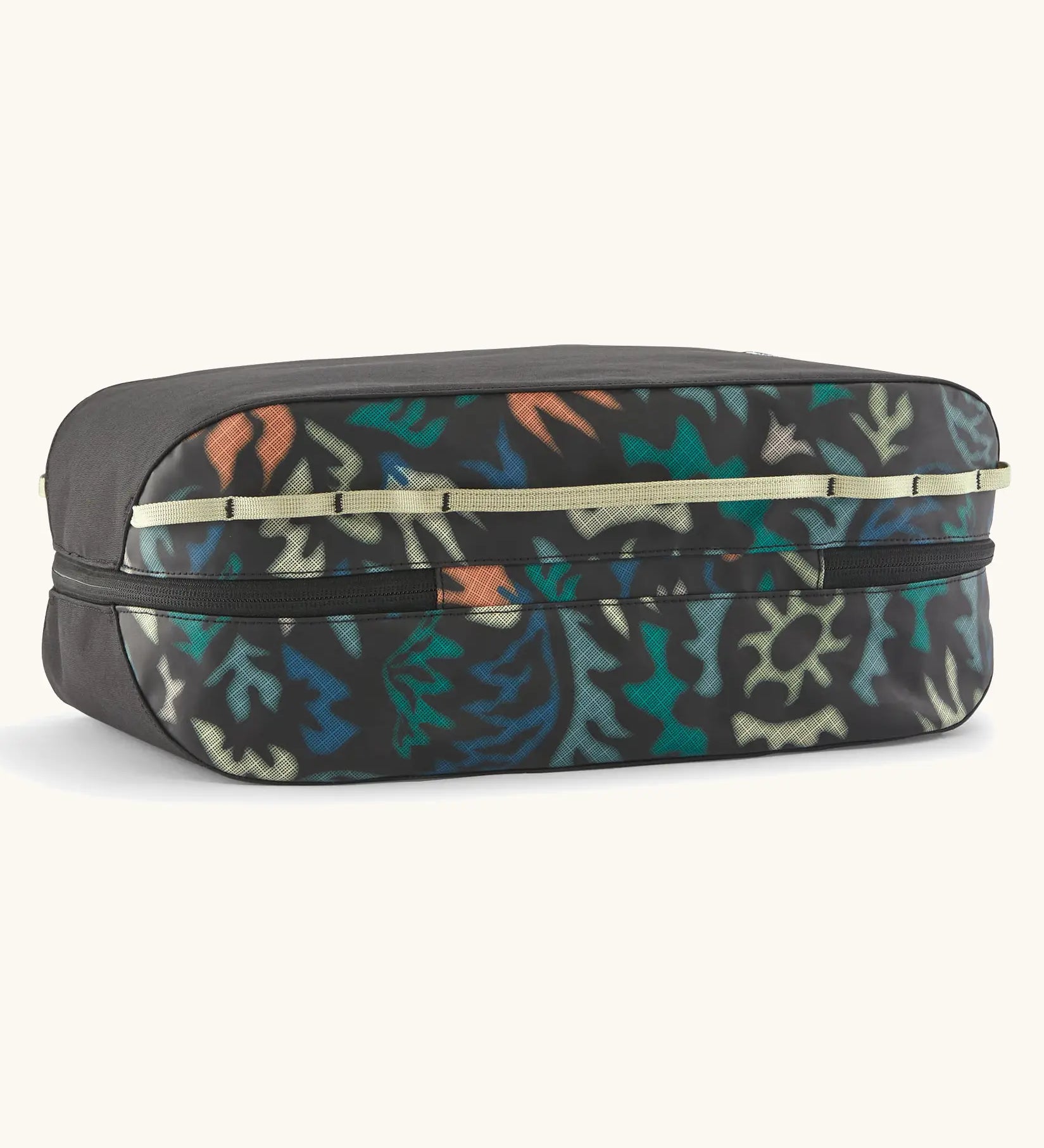 Underside of the Patagonia black hole 14 litre cube bag in black with abstract pattern showing zip running underneath 