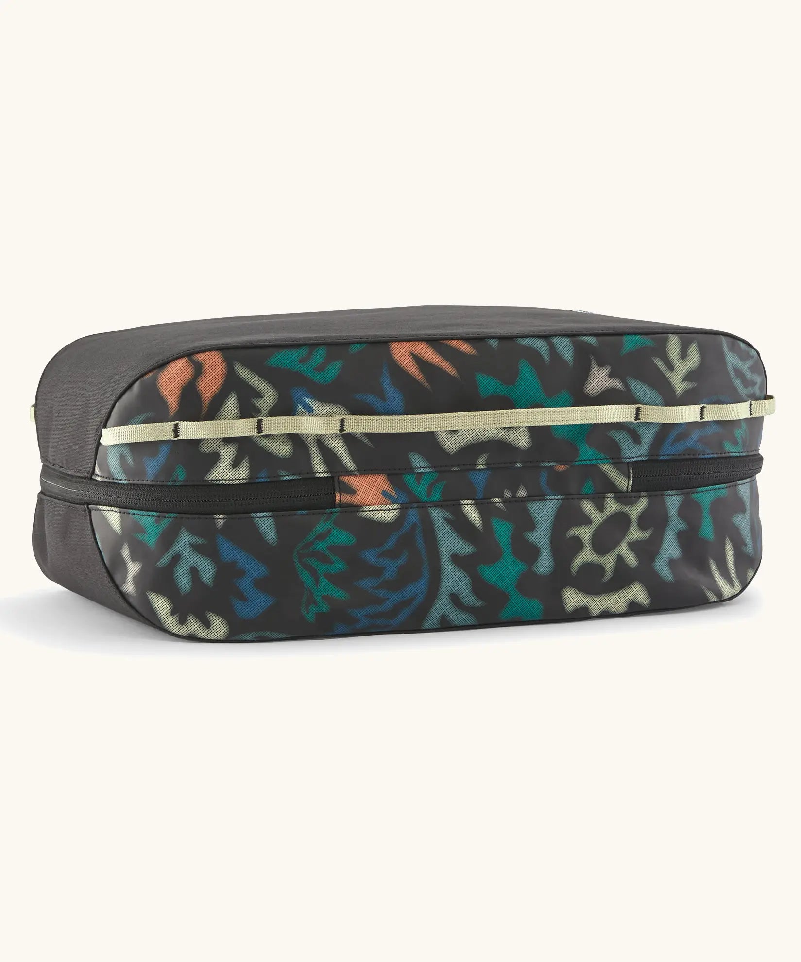 Underside of the Patagonia black hole 14 litre cube bag in black with abstract pattern showing zip running underneath 