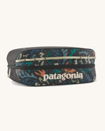 Patagonia black hole 14 litre cube bag in black with abstract pattern design, black zip detail and cream brand text logo on front