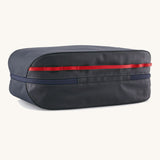 Underside of the Patagonia black hole 14 litre cube bag in dark blue showing zip running underneath and extra red gear loops