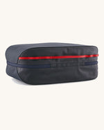 Underside of the Patagonia black hole 14 litre cube bag in dark blue showing zip running underneath and extra red gear loops