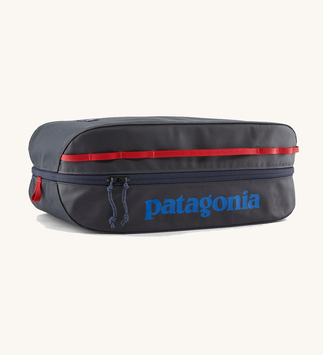 Patagonia black hole 14 litre cube bag in dark blue with matching zip, red gear loops and a blue brand text logo on front panel