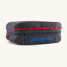 Patagonia black hole 14 litre cube bag in dark blue with matching zip, red gear loops and a blue brand text logo on front panel