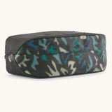 Underside of Patagonia black hole cube 3 litre bag in black with repeating abstract print design