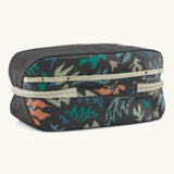 Underside of Patagonia black hole 6 litre cube bag in black with abstract pattern showing cream zip running underneath 