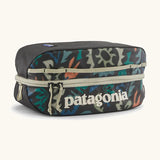 Patagonia black hole 6 litre cube bag in black with abstract pattern design on front panel and cream zip detail