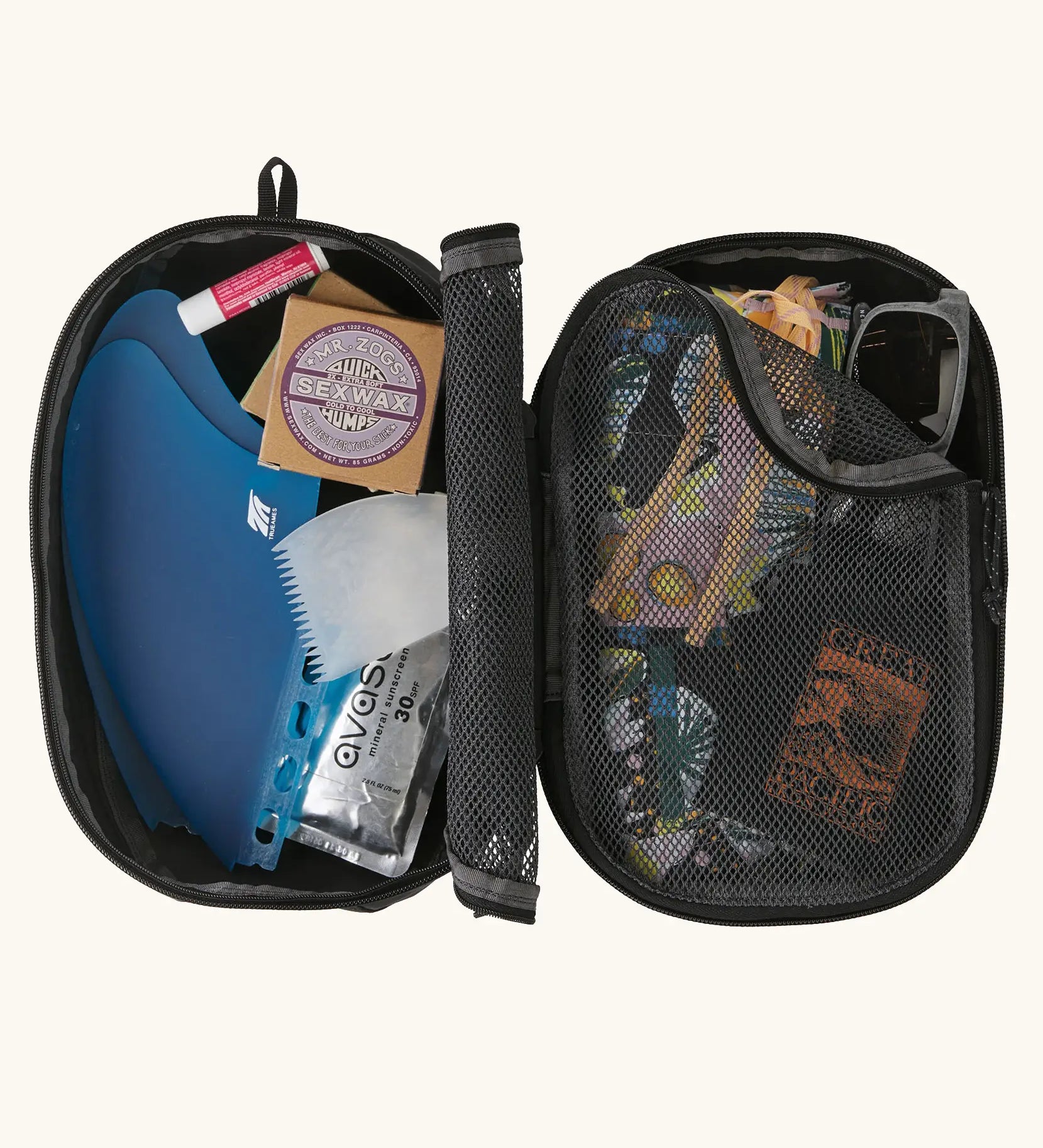 Inside of Patagonia black hole 6 litre cube bag showing opened meshed compartments with outdoor gear inside