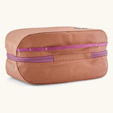 Underside of Patagonia black hole 6 litre cube bag in orange showing purple zip running underneath